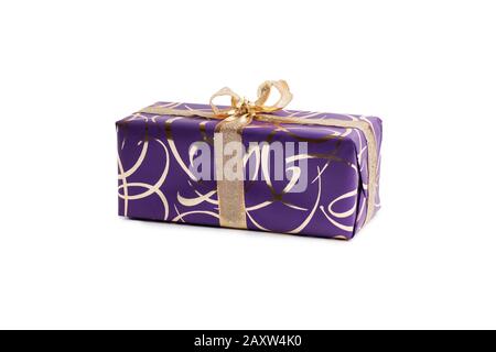 packaged rectangular gift in purple packaging with gold bow and gold pattern on a white background Stock Photo