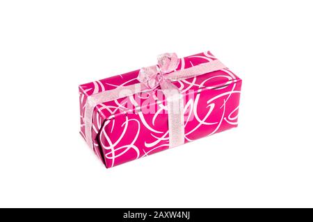 packaged rectangular gift in pink packaging with gold bow and gold pattern on a white background Stock Photo