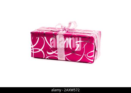 packaged rectangular gift in pink packaging with gold bow and gold pattern on a white background Stock Photo
