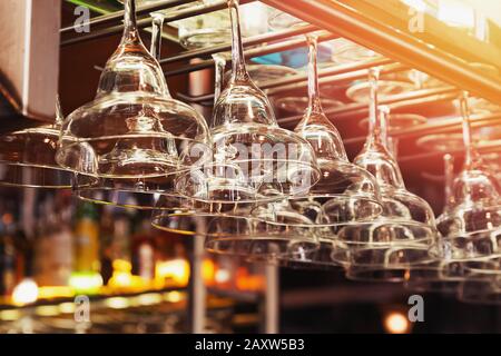 Close up of cocktail glasses hanging in a row Stock Photo