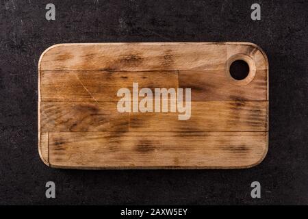Cutting board on black slate background. Mockup Stock Photo