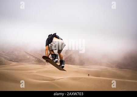 Sandboarding on Atacama Desert. Iquique, Tarapaca Region, Chile. Stock Photo