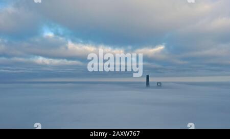 The tips of Shanghai Tower, tallest, and the Shanghai World Financial Center (SWFC) are seen in the dense advection fog shrouding the Lujiazui Financi Stock Photo
