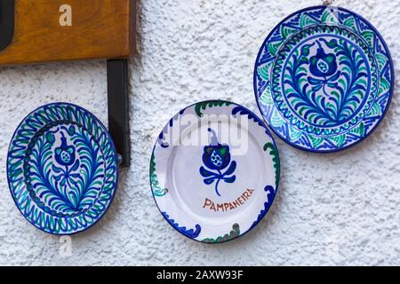 ceramic plates hanging on outside white washed wall in Spanish village of Pampaneira, Andalucia, Spain in February Stock Photo
