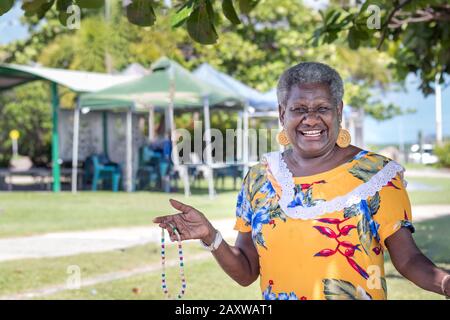Portrait of a melanesian - australian mature woman smiling, outdoors. Stock Photo