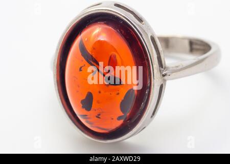 Beautiful silver ring with amber and insect inside isolated on white background Stock Photo