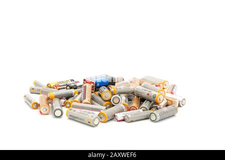 a number of used and depleted batteries photographed on a white background hinting of the need to recycle. Stock Photo