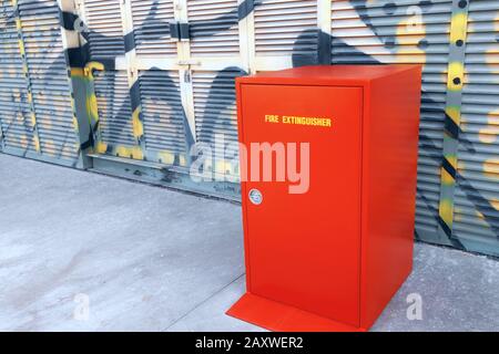 Fire Extinguisher red closet standing near building Stock Photo