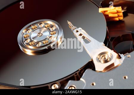 Disassembled hard drive from the computer, hdd with mirror effect. Opened hard drive from the computer hdd with mirror effects. Part of computer pc, l Stock Photo