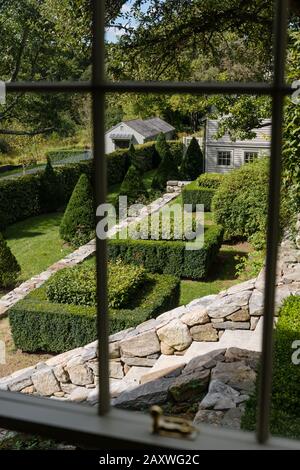 View through window of hedge garden Stock Photo