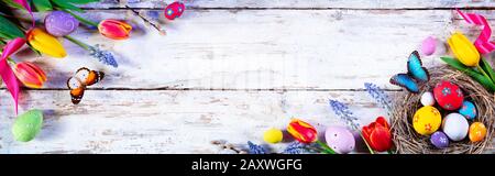 Easter Painted Eggs And Tulips On White Plank Stock Photo