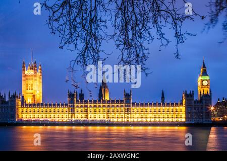 Big Ben and The Houses of Parliament along the river Thames in London at night.
