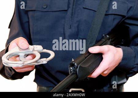 Police officer. With weapons in service. Performs official duties. The inscription in Russian police Stock Photo