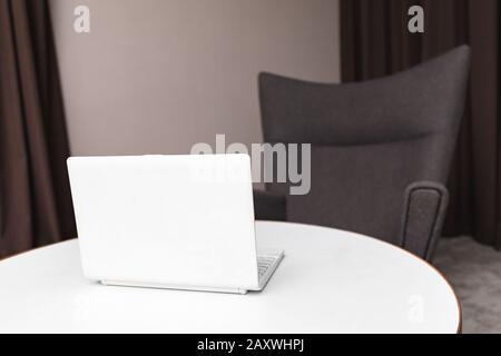 Open notebook pc in empty interior Stock Photo