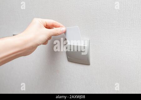 To turn on the electricity in the room the guest of the hotel needs to insert the key card into the reader Stock Photo