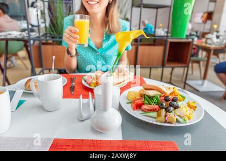 Woman having continental breakfast in hotel cafe Stock Photo