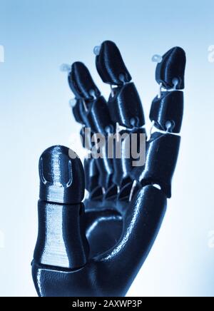 Robot hand fingers from plastic close-up. Automatic three dimensional performs plastic modeling. Modern 3D printing technology. Stock Photo