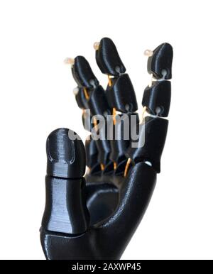 Robot hand fingers from plastic. Isolated on white background. Automatic three dimensional performs plastic modeling. Modern 3D printing technology. Stock Photo