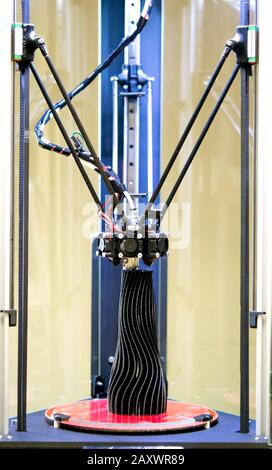 3d printer prints a model of a black vase close-up. Progressive modern additive technologies 4.0 industrial revolution Stock Photo