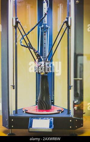 3d printer prints a model of a black vase close-up. Progressive modern additive technologies 4.0 industrial revolution Stock Photo