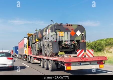 Car towing truck with heavy duty military army fuel tanker. Stock Photo