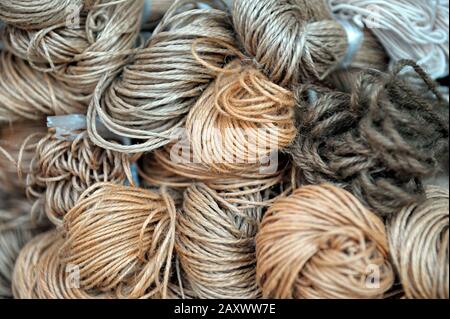 Twines and ropes of different sizes and colors displayed in shop. Stock Photo