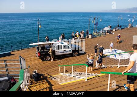 Police Chevrolet Silverado hybrid harbor patrol vehicle on the end of Santa Monica pier with tourists, California, United States of America. Stock Photo