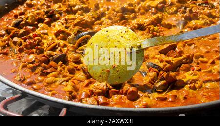 Paella being prepared at outdoor event in Spain. Stock Photo