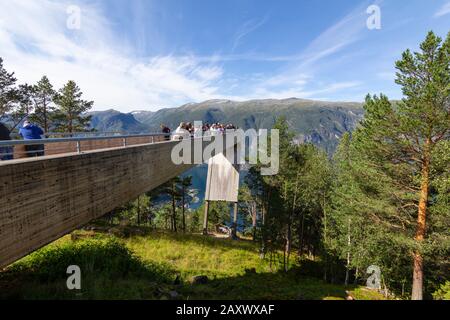 People looking at Aurlandsfjord from the top of Stegastein viewpoint platform, a modern architecture lookout with maje Stock Photo