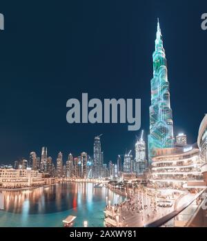 26 November 2019, United Arab Emirates, Dubai: The tallest building in the world - Burj Khalifa, illuminated at night near the pool Stock Photo