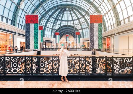 Tourist girl taking selfie photo in one of the largest shopping centers in Dubai - Emirates Mall. Travel destinations in UAE Stock Photo