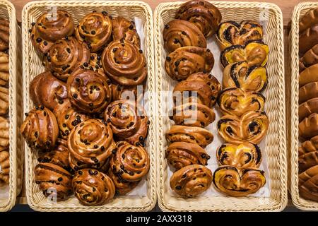 fresh buns with raisins poppy seeds and cinnamon in the mall Stock Photo