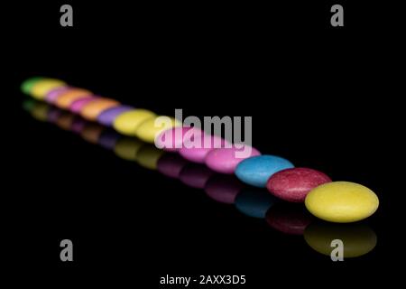 Lot of whole sweet colourful candy isolated on black glass Stock Photo