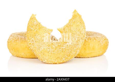 Group of two whole one half of sweet golden mini cinnamon donut isolated on white background Stock Photo