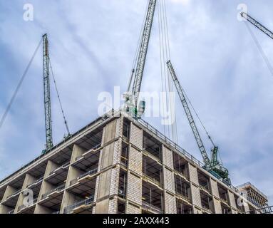Several cranes on constructions sites at high buildings all over London UK Stock Photo