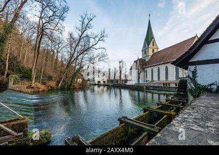 Blue karst spring 'Blautopf' with the hammermill and the Blaubeuren Abbey Stock Photo