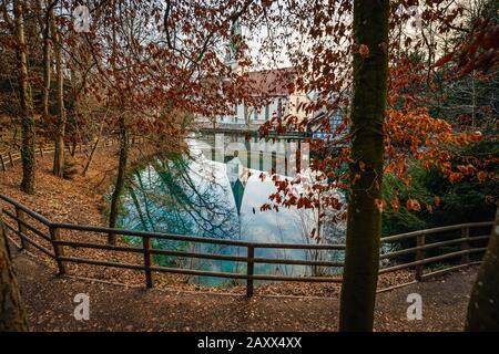 Blue karst spring 'Blautopf' with the hammermill and the Blaubeuren Abbey Stock Photo