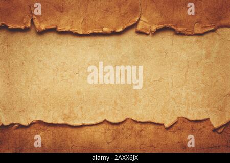 Two old crumpled torn ancient sheets of paper on another vintage sheet of paper with copy space. Template with header and footer for website, menu, ba Stock Photo