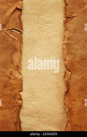Vertical oriented old crumpled torn ancient sheets of paper on another vintage sheet of paper with copy space. Template with two sidebars for website, Stock Photo
