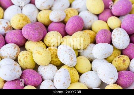 Colourful mini chocolate candy covered easter eggs closeup Stock Photo