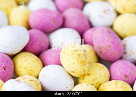 Closeup of some mini colouful chocolate candy covered easter eggs Stock Photo