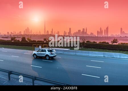 Highway Road and Dubai cityscape skyline at sunset. Transportation and travel in UAE concept Stock Photo