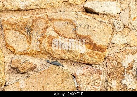 Natural background from natural yellow stone material. Stock Photo