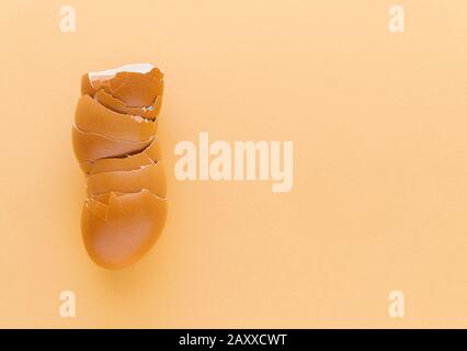 Egg shells on a cream-coloured background. Kitchen concept. Copy space. Stock Photo