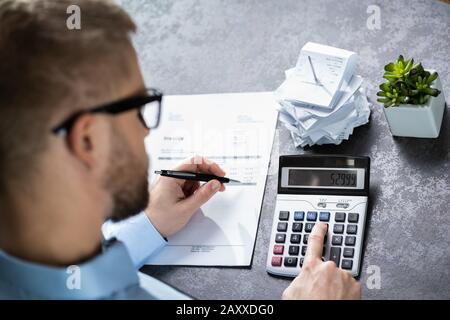 Accountant Calculating Finances. Over The Shoulder View Stock Photo