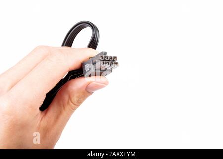 Hand holding up in fingers, presenting one single pc power supply unit black P1 8 eight pin PCI express cable with grey connector isolated on white Stock Photo