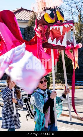 Children & adults dance in fancy costumes at Salida, Colorado's, 3rd annual Lunar New Year Parade. Stock Photo