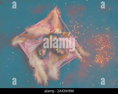blurred creative abstract easter eggs in a gift box with feathers, Easter decoration. Nest with golden red eggs. Greeting card. Happy Easter. Stock Photo