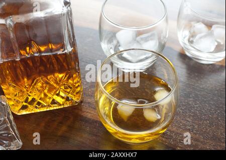 blended scotch whiskey served in a short glass with a large ice cube  isolated on a white background Stock Photo - Alamy