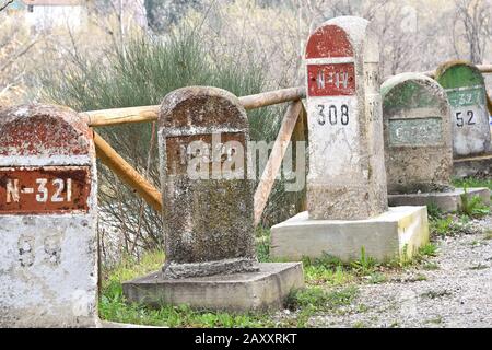 Old milestones exposed on the Bailen-Motril road (N-323) as it passes through La Cerradura de Pegalajar (Jaen-Spain) Stock Photo